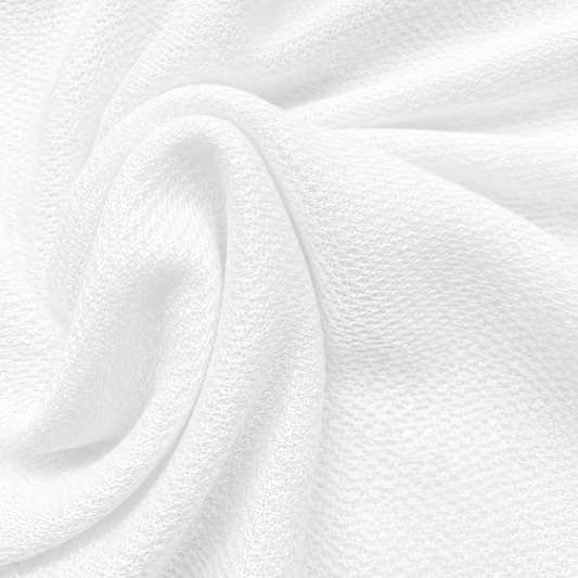 Micro Nirmal knit fabric
white knitted fabric
breathable activewear fabric
polyester knit fabric
wholesale T-shirt fabric
bulk apparel fabric supplier
Close-up of white Micro Nirmal Knit fabric arranged in soft folds, showing its fine knitted texture and lightweight drape.