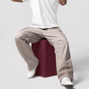 Man wearing beige gym track pants for sports and casual wear
Men’s gym track pants front view
Men wearing athletic track pants for gym training
Men’s sports track pants side view
Zip pocket detail on men’s gym track pants
Men’s track pants elastic waistband detail