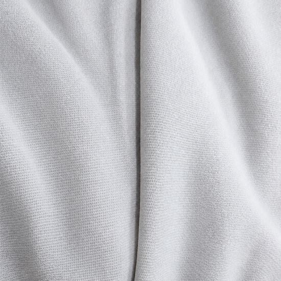 Adidas Saleena white knit fabric spiral view showing soft texture and premium polyester sportswear fabric quality