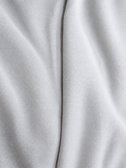 Adidas Saleena white knit fabric spiral view showing soft texture and premium polyester sportswear fabric quality