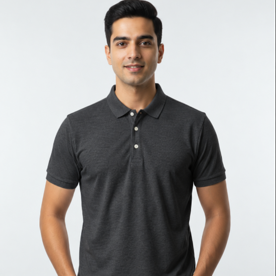 A man wearing a dark gray short-sleeve polo shirt, standing against a light gray background.